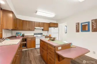 An open "lazy Susan" corner cabinet display, makes for easy access to large cookware. The "rose tone" laminate from yesterday is back in style today and on target with modern color trends.