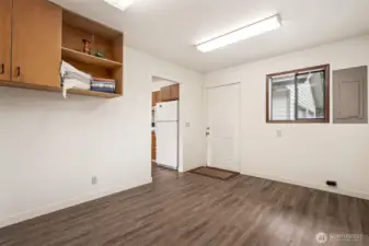 The back entry door off the kitchen/utility room leads directly to the detached garage and back acres.  Design a boot bench and coat hooks on this side of the room and keep the raincoats and mud boots contained here!