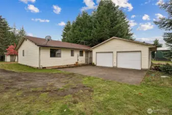The rains of November paused for moment to give a hint of spring and summer to come at this quaint property.  Imagine your version of a gravel drive but for now the concrete parking pad keeps parking tidy.