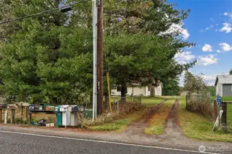 The main entrance to the home is the private driveway off Military road.  The cyclone fence does include a gat that can close the driveway off.