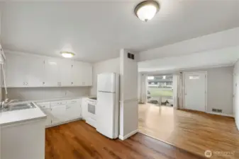 From Dining Room looking into U shaped Kitchen on the left and Living room/entry on the right