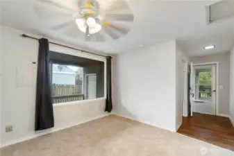 Large window in Family room looking out at door leading to shop/hobby room on the left and down hallway to back door on the right
