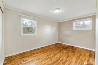 Primary Bedroom with Hardwood floors and long sliding closet doors on the far left