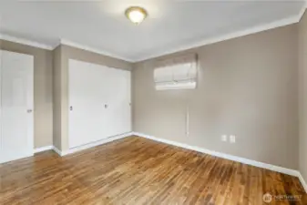 2nd Bedroom showing off the sliding wood doors of the closet... Primary bedroom has 3 doors for it's closet
