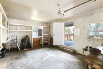 ntrance door on the right leading into previous shop for an iron worker. Yes, small frig stays with the home. More items still to be removed from shop