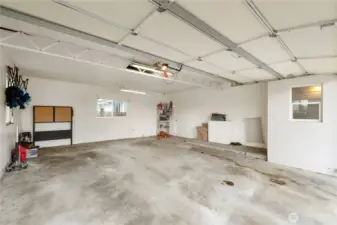 Large 2 car garage with back door leading to 2nd covered patio