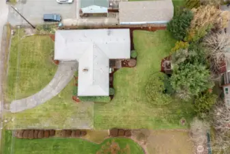Overhead view of whole lot showing graveled additional parking on the right of the curved driveway. Great look at freshly landscaped yard!