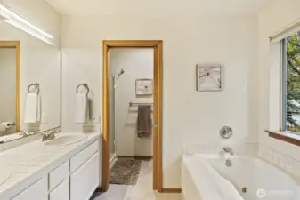 Soak your troubles away in the tub while looking out at the gorgeous wooded setting - this primary bath really feels like a trip to the spa!