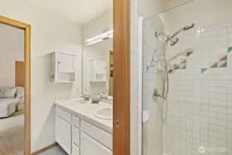 Dual vanities, a jetted soaking tub, and a glass walk-in shower - the perfect place to put on a fresh face for the day.