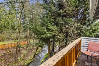 The primary bedroom enjoys its own private balcony overlooking your private backyard oasis, including Thornton Creek!