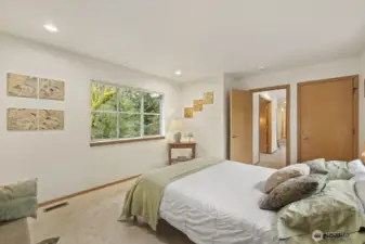 Windows on both sides of the room fill the space with warm light and calming views.