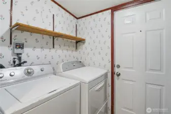 Laundry room, located just off kitchen with access to the side porch and yard.