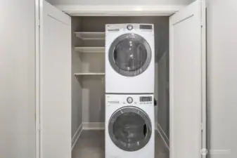 Utility Room with Selves and Full-Size Washer and Dryer