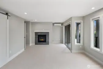 Primary Bedroom with Matching Cozy Fireplace with Stone Accent and Mantle.