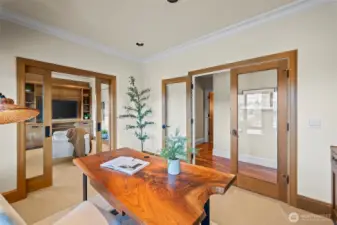 This sophisticated office flows seamlessly into a private secondary living room, offering a quiet, self-contained wing for focused work or relaxed reflection.