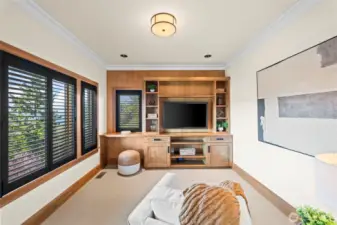 Tucked away from the home’s main social hub, this secondary living room offers a peaceful retreat for relaxation, characterized by the same high-end finishes and architectural volume found throughout the home.