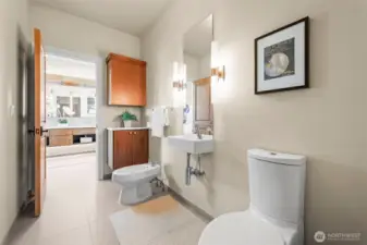 Continuing the home's theme of uncompromising luxury, this private water closet offers a refined sanctuary featuring a premium bidet and a dedicated vanity for added convenience.