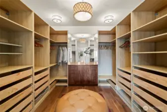 More than a closet, this space is a private gallery for your wardrobe. The expansive built-in storage system offers effortless organization, while designer light fixtures cast a sophisticated glow over the artisanal woodwork.