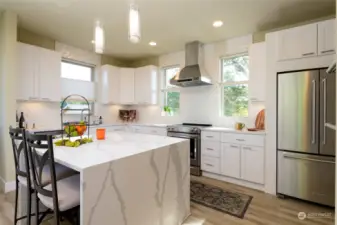 Kitchen with quartz counter top, walk in pantry and double oven.