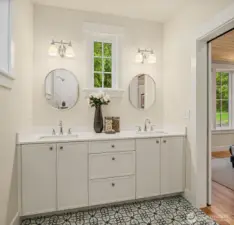 The generous primary bath includes double sinks and is filled with light from the south facing windows.