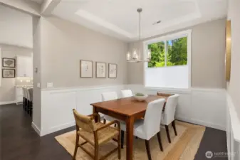 The dining room is open yet separated from the kitchen so everyone can focus on their dinner companions rather than any mess in the kitchen.
