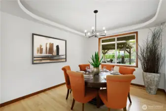 Formal dining room with newly refinished hardwood floors and views of the back yard.  Portions of this photo are virtually staged.