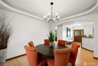 Formal dining room with inset ceiling lighting, opens to entry and kitchen.