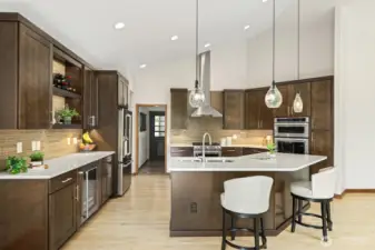 Remodeled Gourmet kitchen includes spectacular island, quartz countertops with custom tile backsplash, custom cabinets and  exceptional stainless appliances.