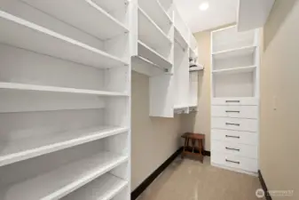 One of two large walk-in closets with custom cabinetry.