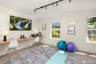 Large upstairs flex room has built-in desk plus exercise space plus room for a guest bed.