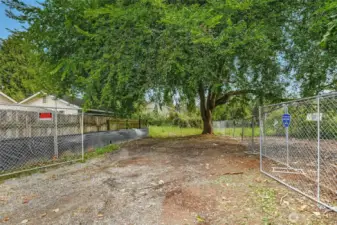 Enter off Park St, driveway easement over multi-family vacant parcel.