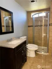 Bathroom w/tiled shower in Main home