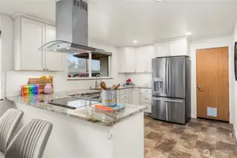 Beautifully remodeled kitchen boasts stianless steel appliances (all stay!) and modern white cabinetry.