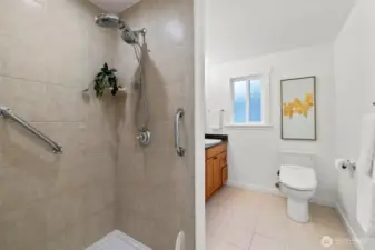 The generous Primary bath features tile floors and a tiled walk-in shower