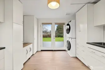 Here's a surprise! This bonus / flex space is amazing. Lots of built-in cabinets, stacking W/D, and a utility sink. The French doors lead to the oversized back deck.