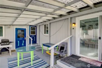 Large deck showing access to multi-purpose room and back door entrance.