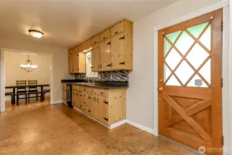 Another hardwood door leads outside to the entertainment deck and backyard.