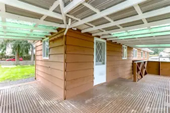 From the kitchen you can go out to deck with stairs to the front yard and stairs down to the backyard as well.