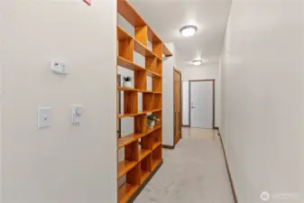 Hallway, view toward front door. On left are bedroom area, laundry/utility closet and bathroom