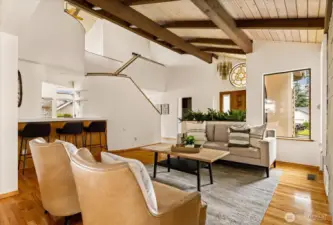 Living room off entry with architectural roof lines and wood floors