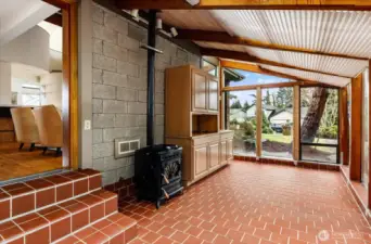 Sunroom with opening to large partially fenced yard off living room