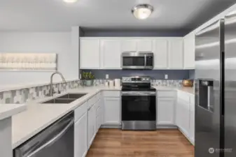 Beautiful kitchen- stainless steel appliances and a cool backsplash.