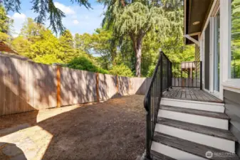 The fully fenced backyard provides privacy and space for kids, pets, and a BBQ grill.