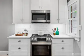 A study in balance: clean subway tile, polished hardware, and a top-tier gas range sit quietly within the home’s historic frame. This is a kitchen made for both craft and comfort—where evening meals and lifelong memories simmer side by side.