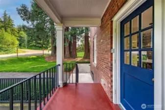 Step through the cobalt-blue door and into a world set apart—where mornings begin with the rustle of leaves and evenings end in the long hush of twilight. This covered side porch, once trodden by uniformed feet, now welcomes a gentler rhythm of homecoming.