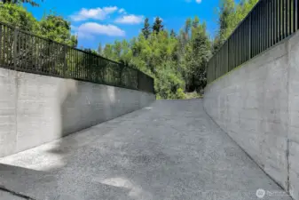 A rarity among Fort Lawton homes, 4404 Montana Circle features an attached garage—sparing you from rainy-day dashes and offering seamless access year-round. Nestled discreetly at the rear, this private drive blends utility with the surrounding forested tranquility.