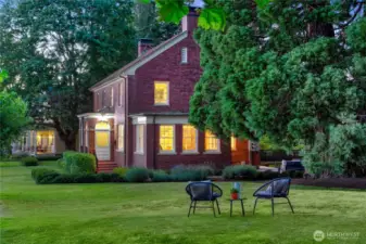 Evening descends over the private green, where a quiet moment beneath the sequoias becomes a daily ritual. Once grounds for military order, this lawn now invites slow conversation, laughter among friends, and the kind of stillness only possible when home is surrounded by forest, meadow, and sky.