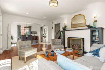 Arched entries and original wood burning fireplace, enhanced with custom built-ins and wood mantle, feels elegant and timeless