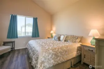 Spacious primary suite also features vaulted ceilings.