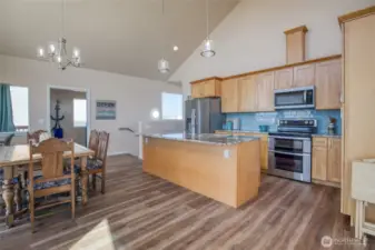 Kitchen features granite countertops, stainless steel appliances, and a gorgeous tile backsplash that compliments the ocean views.